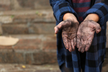 Poor homeless child begging for help outdoors, closeup