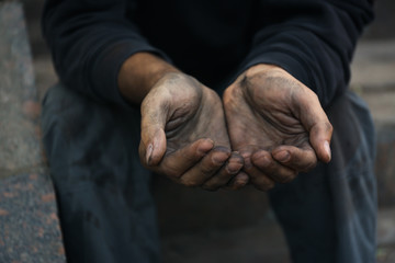 Fototapeta premium Poor homeless man begging for help outdoors, closeup