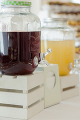 Glass jars of lemonade on wedding candy bar. Catering. Drinks on wedding party