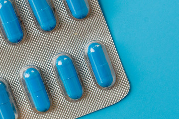 Medications, pills, thermometer, traditional medicine for treating colds, flu, heat on a blue background. Maintenance of immunity. Seasonal diseases. Top view. Medicine flat lay