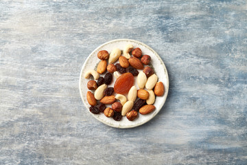 Nuts, raisins and apricots on rustic wooden background. Concept for healthy snack. Top view. Copy space. 