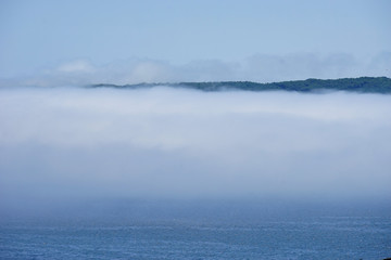 Far Eastern fog over the sea surface against