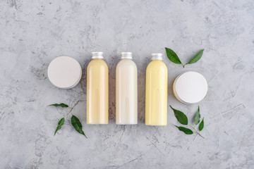 Bottles with spa cosmetic products on grey background