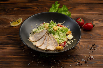 Caesar San Salad of Romano leaves, chicken, cherry tomatoes, egg, breadcrumbs, Parmesan cheese, Caesar sauce and tobiko