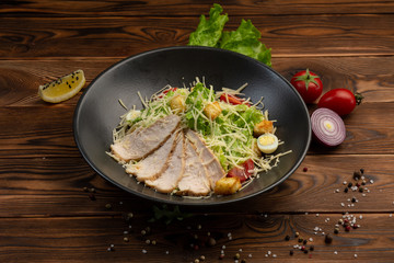 Caesar San Salad of Romano leaves, chicken, cherry tomatoes, egg, breadcrumbs, Parmesan cheese, Caesar sauce and tobiko