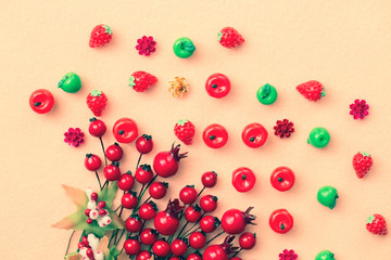 Beautiful autumn background, artificial miniature apples and red rosehip berries