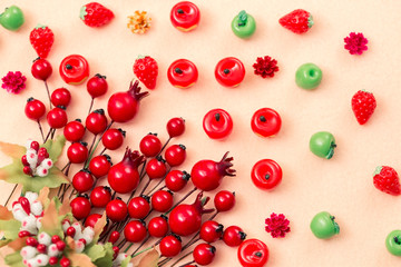Beautiful autumn background, artificial miniature apples and red rosehip berries