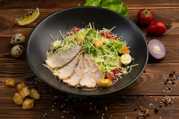 Caesar San Salad of Romano leaves, chicken, cherry tomatoes, egg, breadcrumbs, Parmesan cheese, Caesar sauce and tobiko