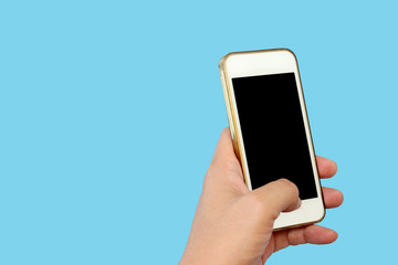 Hand holding phone isolated on blue background with clipping path.