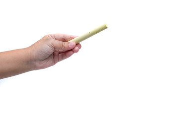 kid hand hold yellow chalk isolated white background