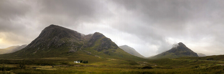 White stone cottage at Buachaille Etive Mòr, Glencoe, cloudy dramatic sky © James Stone