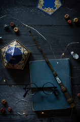 magic wand and spell books on desk with glasses and other witch items, wizards desk, halloween...