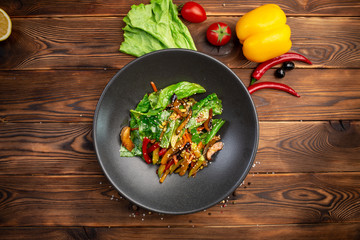 Fried wok vegetables: eggplant, carrots, mushrooms, zucchini, red onions, soy sprouts and spinach leaves fried in teriyaki sauce