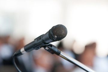 Microphone In the seminar room,blurred people background.