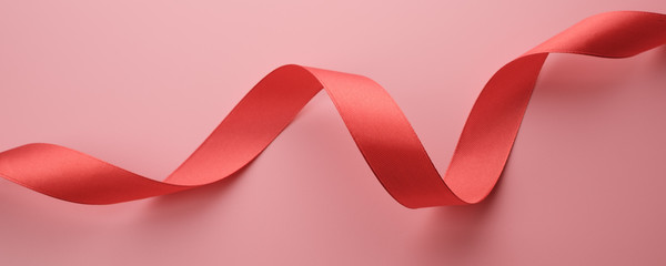 Red ribbon on pink background, banner concept