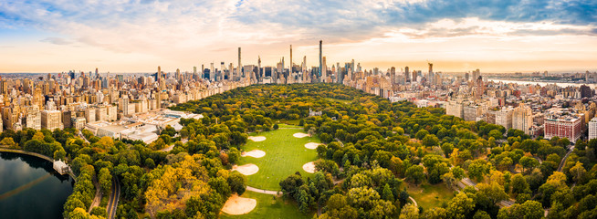 Aerial panorama of New York midtown skyline at sunset viewed from above Central Park.
