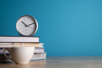 Clock on stack of book, school education background