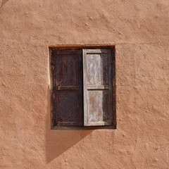 Ancient traditional residential old house wall and wooden window in Tuyoq village valley inTurpan Xinjiang Province China.