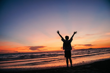 Fototapeta na wymiar Happy man on the sunset in nature in summer with open hands