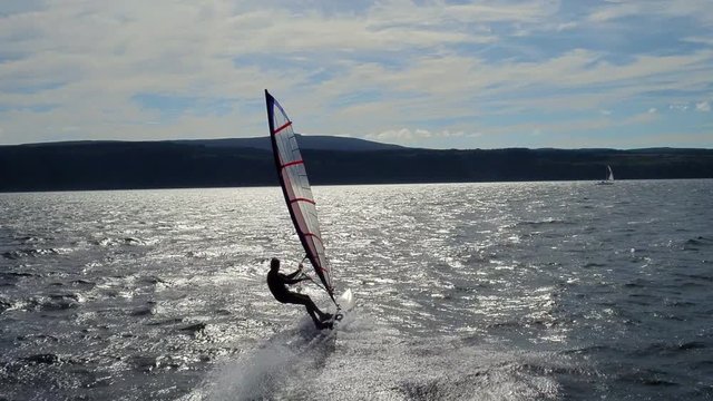 Low, fast and dramatic windsurfing aerial shot from a drone