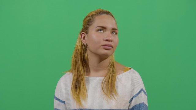 Woman Head Turning Like A Sign Of Stress Or Trying To Relax A Tired Body. Studio Isolated Shot Against Green Screen Background