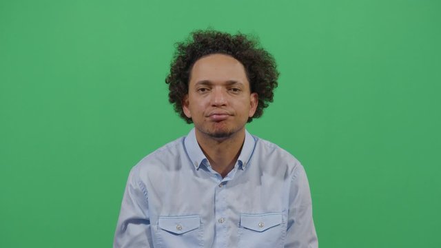 Facial Expression Of A Adult Man Pouting. Studio Isolated Shot Against Green Screen Background