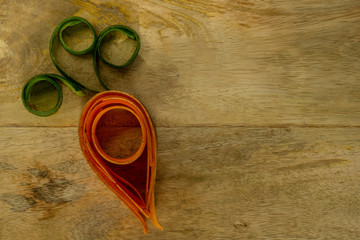 a compound carrot of cucumber and carrot on a wooden board - 295574528
