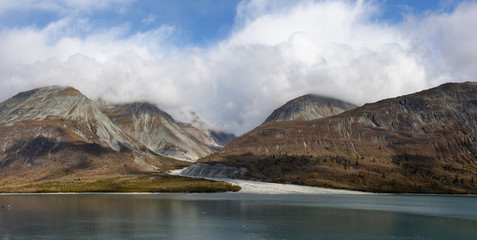 Beautiful Panoramic View of a Glacier in the American Mountain Landscape on the Ocean Coast during a cloudy morning in fall season. Taken in Glacier Bay National Park and Preserve, Alaska, USA.