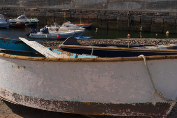 Old wooden fishing boats in a small harbor on the Canary islands - 295574785