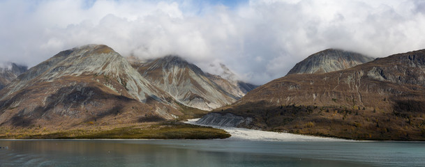Beautiful Panoramic View of a Glacier in the American Mountain Landscape on the Ocean Coast during a cloudy morning in fall season. Taken in Glacier Bay National Park and Preserve, Alaska, USA.