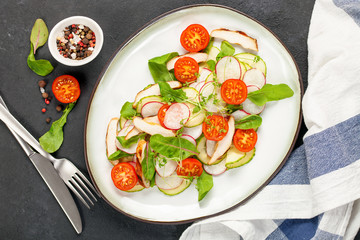 Fried chicken fillet and fresh vegetable salad .