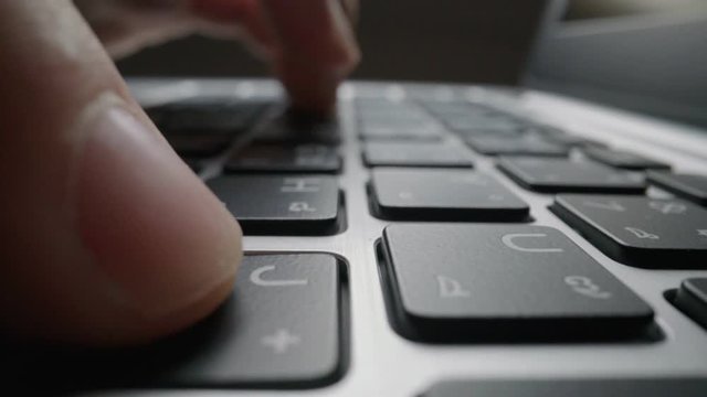 Time lapse close-up man typing on computer keyboard with fingers. Macro soft focus dolly shot. Computer programming, text chat online messaging and online marketing business hyperlapse concept.
