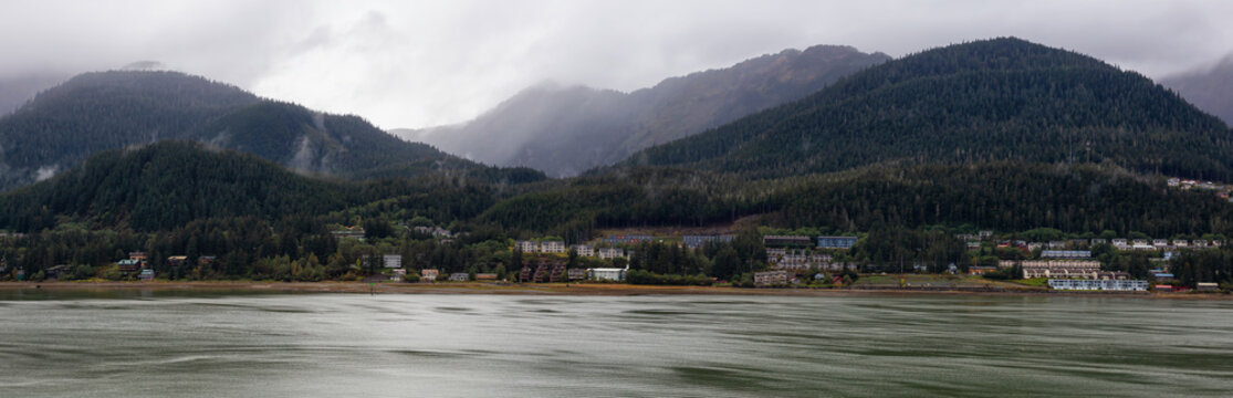 Beautiful Panoramic view of a small town, Juneau, during a cloudy morning with mountains in the background. Taken in Alaska, United States.