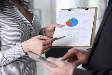 businessmen study documents at office