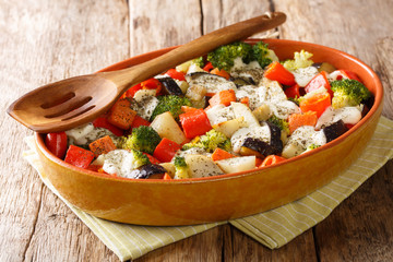 Homemade vegetable casserole with mozzarella cheese close-up in a baking dish. horizontal