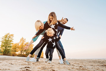 Happy family having fun by the river