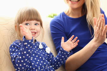 Cute little girl play with mom pat-a-cake at home portrait. Love care friendship parrent casino...