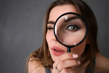 Young beautiful woman portrait looks painful eye lens search on Internet information employer does...