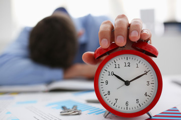 Businessman in blue shirt asleep at work on the background of a bottle of alcohol, overslept...