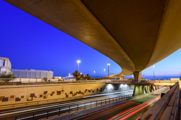Beautiful light trails of fast-moving traffic at the blue hour in Bahrain