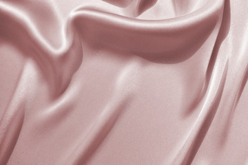 Delicate satin draped fabric pink texture for festive backgrounds