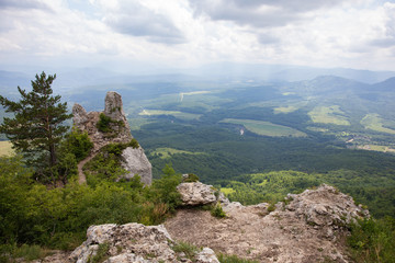 Fototapeta premium View of the valley, sky and clouds from a high cliff 