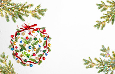 Christmas composition  with red ribbon ,branches of fir tree and Christmas ornaments in shape of Christmas bauble on white background.