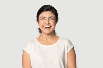 Overjoyed indian girl laugh posing on grey background