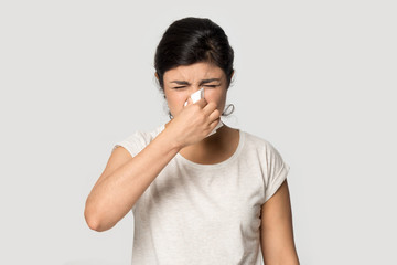 Sick indian girl blow nose suffering from fever