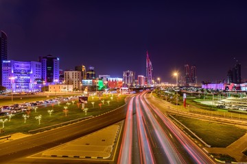 Illuminated Manama city with beautiful light trails at night.