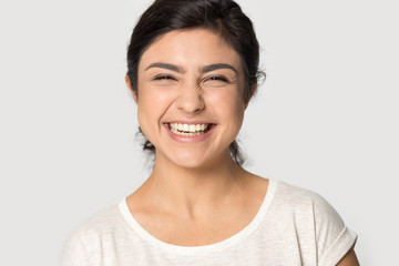 Headshot portrait of excited indian girl posing in studio