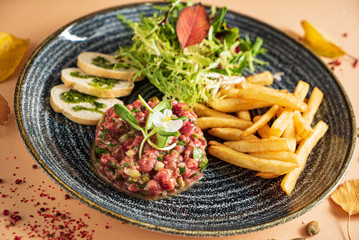 beef tartare with salad and french fries