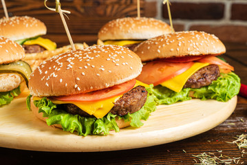 burgers with french fries on the wooden background