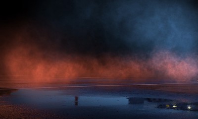 Wet asphalt, reflection of neon lights, a searchlight, smoke. Abstract light in a dark empty street with smoke, smog. Dark background scene of empty street, night view, night city.
